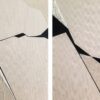 Contemporary abstract diptych painting with sharp black lines, textured beige surface, and embedded white stone fragments by Veronika Obushikhina, from the Resilience series