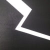 Minimalist abstract painting part with a sharp white fractured line on black background by Veronika Obushikhina